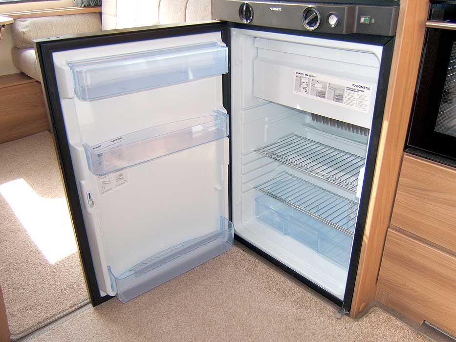 An interior view of the fridge with freezer top box.